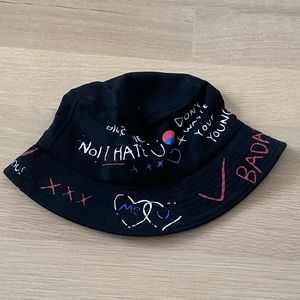 black bucket hat with bright words all around